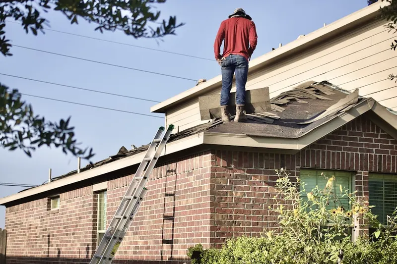 Professional roofer working on a residential roof in Presidential Estates